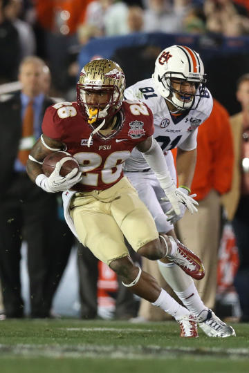 Jan 6, 2014; Pasadena, CA, USA; Florida State Seminoles cornerback P.J. Williams (26) returns an interception against Auburn Tigers during the 2014 BCS National Championship. (Matthew Emmons-USA TODAY Sports)