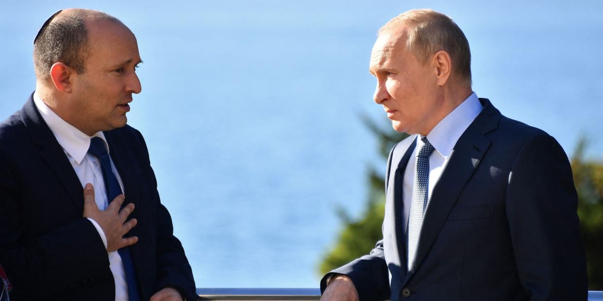 Russian President Vladimir Putin (R) speaks with Israeli Prime Minister Naftali Bennett during their meeting, in Sochi, on October 22, 2021.