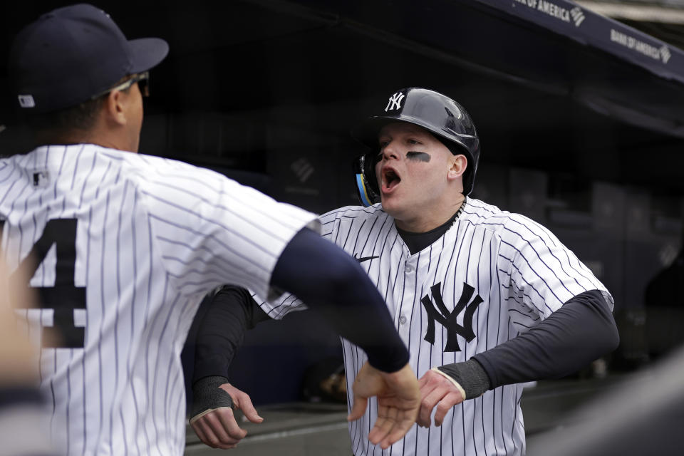 New York Yankees' Alex Verdugo, right, reacts with Jahmai Jones, left, after scoring during the fifth inning of a baseball game against the Tampa Bay Rays, Sunday, April 21, 2024, in New York. (AP Photo/Adam Hunger)