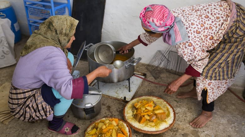 Moroccan women making couscous