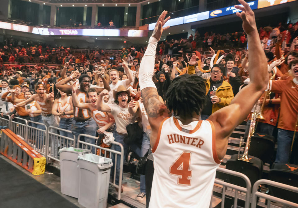 Texas guard Tyrese Hunter celebrates with the Texas Student section after defeating Baylor on his shot at the buzzer during an NCAA college basketball game against Baylor, Saturday, Jan. 20, 2024, in Austin, Texas. Texas won 75-73. (AP Photo/Michael Thomas)