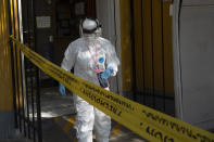 A healthcare worker takes part in a house-to-house campaign to help curb the spread of the new coronavirus, in the Mallasa neighborhood of La Paz, Bolivia, Saturday, Aug. 8, 2020. (AP Photo/Juan Karita)