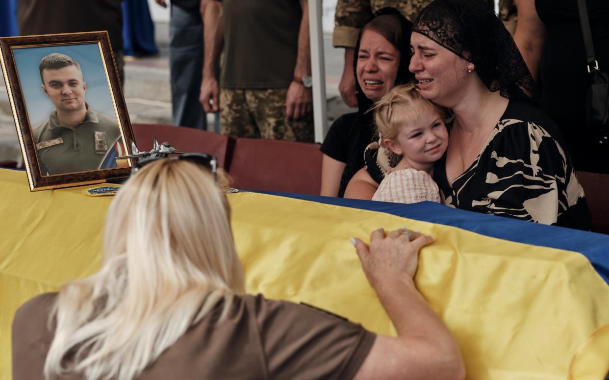 Hundreds attend the funeral service of F-16 pilot Oleksiy Mest in Shepetivka, Ukraine on August 29