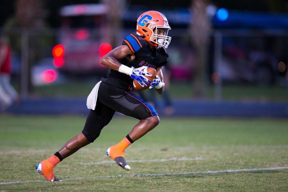 Palm Beach Gardens Malcolm Tucker runs with the ball during game against Palm Beach Central at Palm Beach Gardens, Florida on October 22, 2021. 