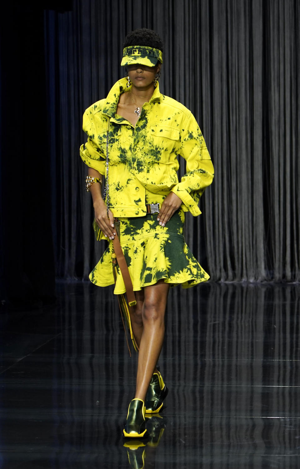 A model wears a creation as part of the Ferrari women's Spring Summer 2023 collection presented in Milan, Italy, Sunday, Sept. 25, 2022. (AP Photo/Alberto Pezzali)