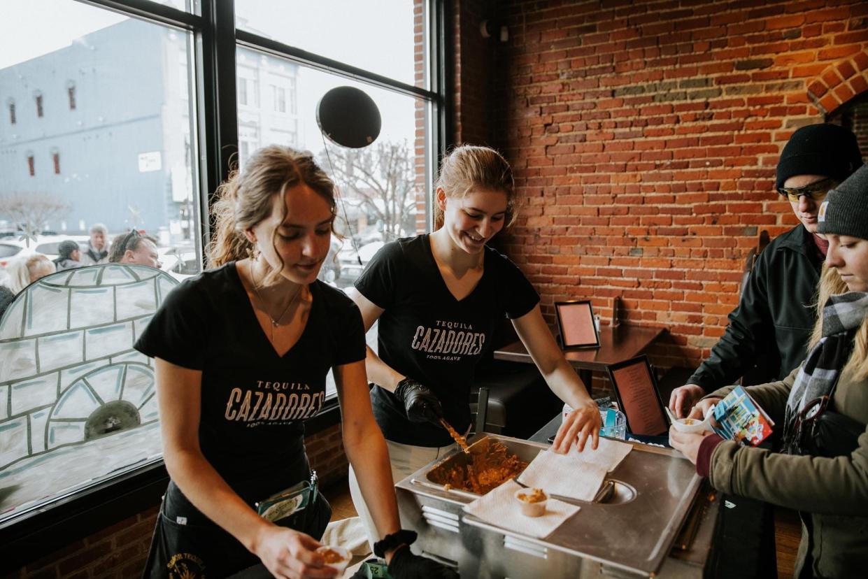 Employees from Senor Tequila scoop chili during the 2023 Chilly Fest Chili Crawl. This year, there are 16 participating restaurants in the competition.