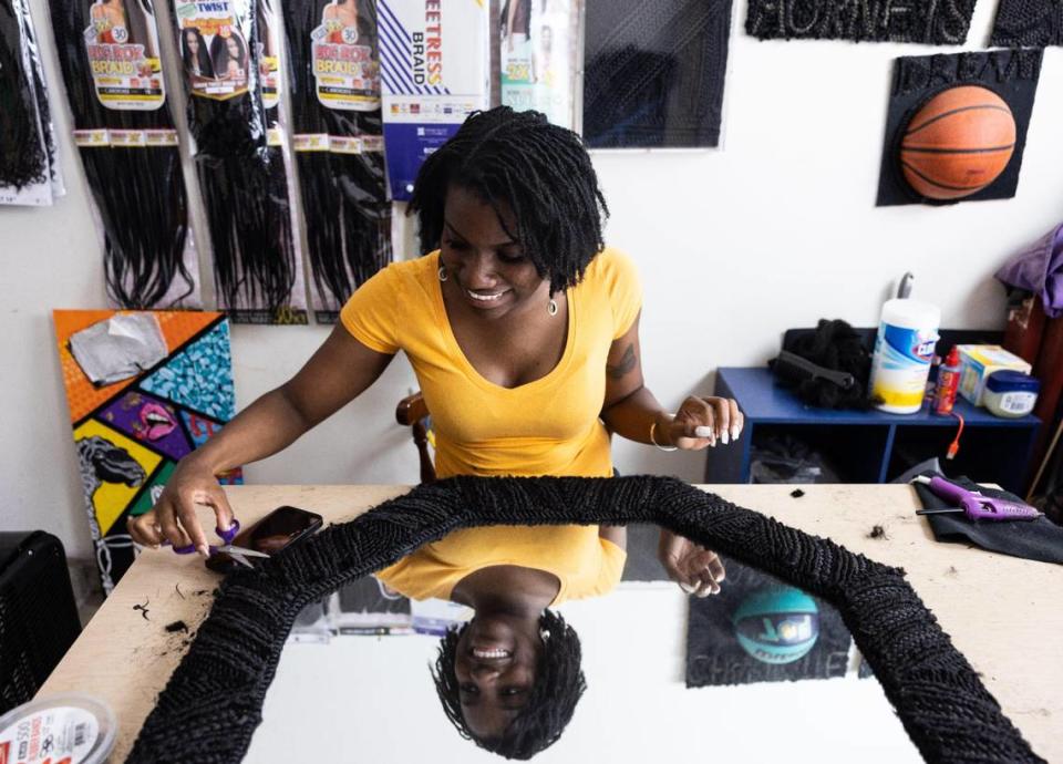 Nadia Meadows touches up one of her projects inside her garage studio in Charlotte. She recently was awarded a competitive South Arts’ State Fellowship for Visual Arts.