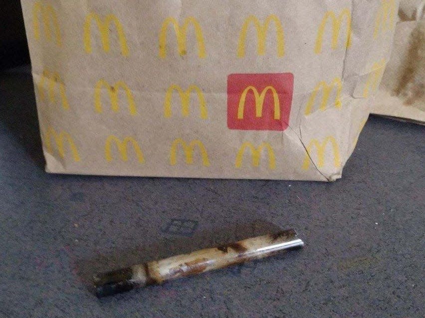 A photo showing an alleged glass crack pipe in front of a McDonald's paper bag