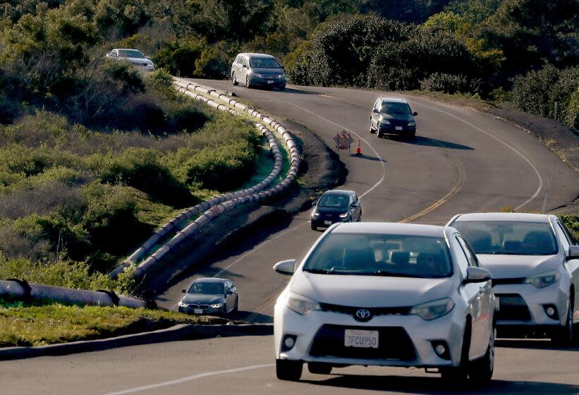 RANCHO PALOS VERDES, CALIF. - MAR. 3, 2023. Sewage pipes run above ground along Palos Verdes Drive South at Portuguese Bend, where a stretch of roadway is uneven and erratic because of land movement on the coastline. (Luis Sinco / Los Angeles Times)