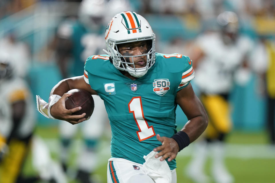 Miami Dolphins quarterback Tua Tagovailoa (1) runs the ball during the first half of an NFL football game against the Pittsburgh Steelers, Sunday, Oct. 23, 2022, in Miami Gardens, Fla. (AP Photo/Wilfredo Lee )