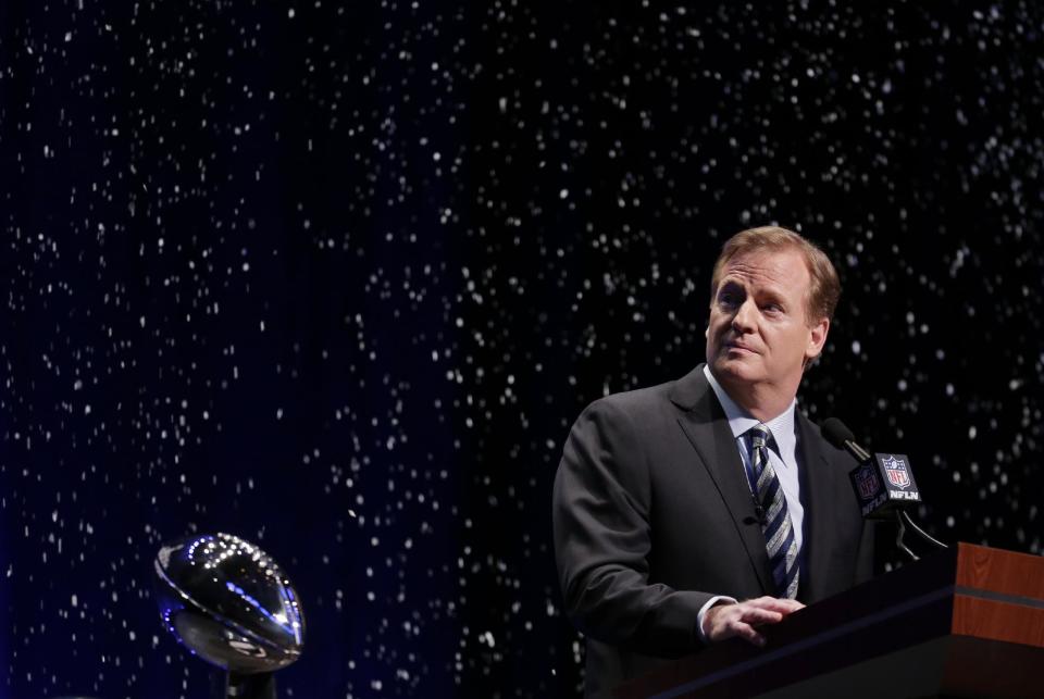 NFL comissioner Roger Goodell looks at artificial snow falls on stage as he speaks at a news conference Friday, Jan. 31, 2014, in New York. The Seattle Seahawks are scheduled to play the Denver Broncos in the NFL Super Bowl XLVIII football game on Sunday, Feb. 2, at MetLife Stadium in East Rutherford, N.J. (AP Photo/Charlie Riedel)