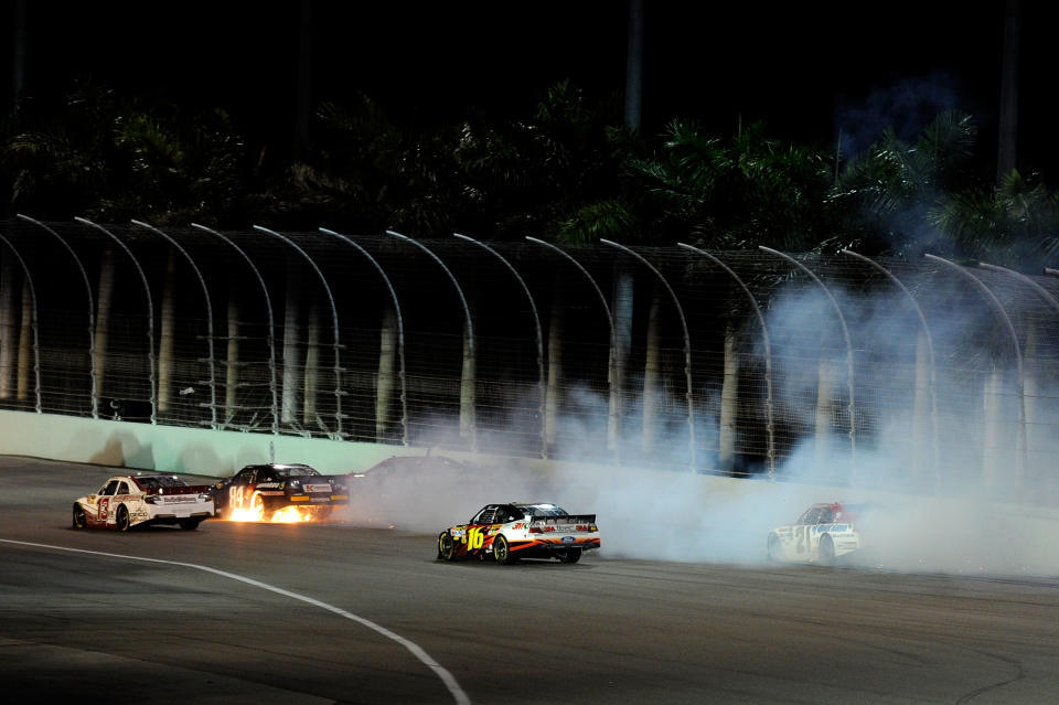 HOMESTEAD, FL - NOVEMBER 20: Cole Whitt, driver of the #84 Red Bull Racing Team Toyota, collides with Landon Cassill, driver of the #51 Thank A Teacher Today/Security Benefit Chevrolet, after an incident during the NASCAR Sprint Cup Series Ford 400 at Homestead-Miami Speedway on November 20, 2011 in Homestead, Florida. (Photo by John Harrelson/Getty Images for NASCAR)