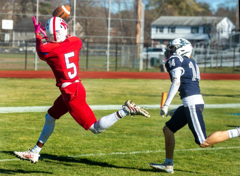 Natick High School senior captain Arnold Kawere with a touchdown catch against Framingham during the Thanksgiving game at Bowditch Field, Nov. 23, 2023.