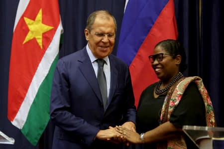 Russian Foreign Minister Sergey Lavrov poses for a photo with Suriname's Foreign Minister Yldiz Pollack-Beighle at the Foreign Affairs Ministery in Paramaribo