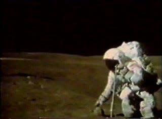 A TV camera still image showing Charlie Duke about to pick up sample 61016, better known as "Big Muley," on the rim of Plum crater. It is the largest rock sample retrieved from the moon during the six Apollo missions that touched down on the surface.