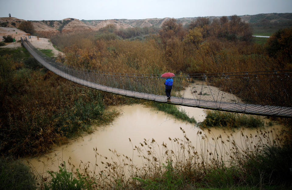 A man walks on a bridge crossing near Kibbutz Tze’elim