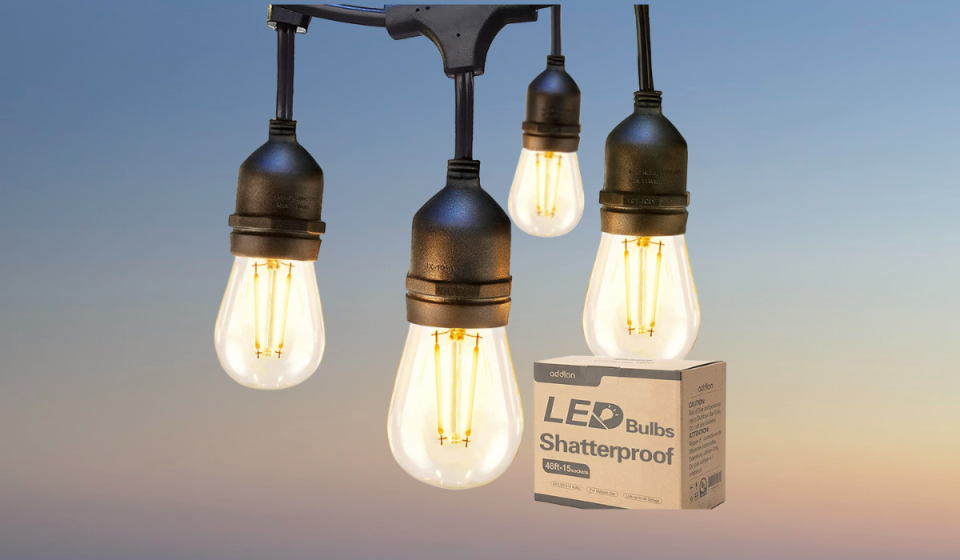 Edison-style bulbs hang from black wire next to a small brown box reading 'LED Bulbs Shatterproof'.