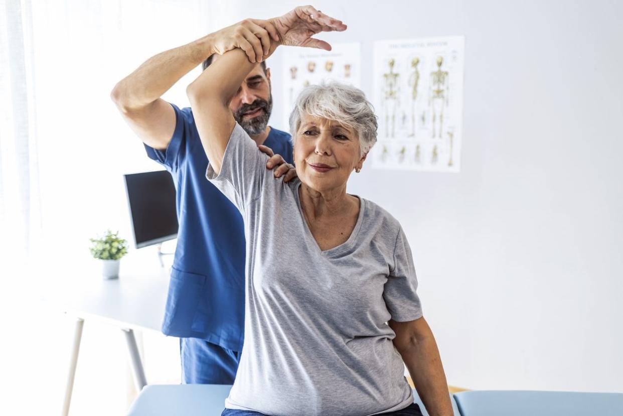 An image of an elderly woman having work done at the chiropractor.