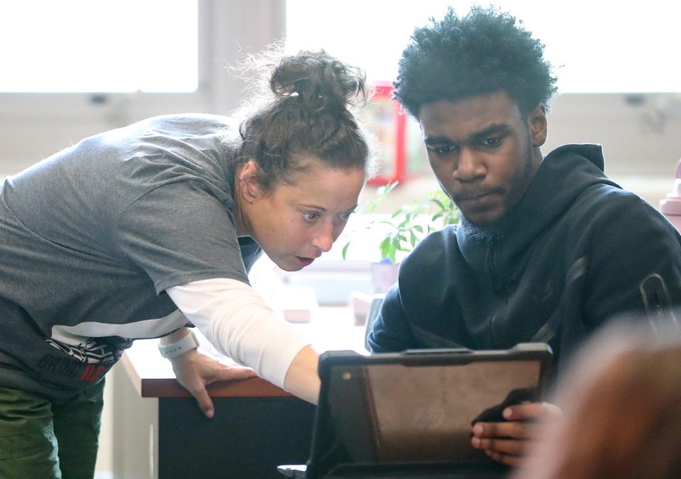Teacher Erin Irwin Saal assists student Johnathan White during the AP African American Studies course at Firestone CLC.