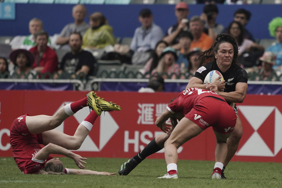 New Zealand's Portia Woodman-Wickliffe tries to break away from Canada's Shalaya Valenzuela during the second day of the Hong Kong Sevens rugby tournament in Hong Kong, Saturday, April 1, 2023. (AP Photo/Anthony Kwan)