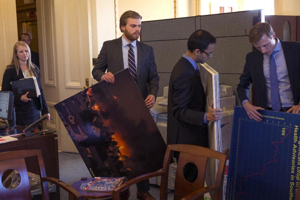 Senate staff members arrive prior to a meeting of the Senate Climate Action Task Force prior to taking to the Senate Floor all night to urge action on climate change on Capitol Hill on Monday, March 10, 2014, in Washington. (AP Photo/ Evan Vucci)