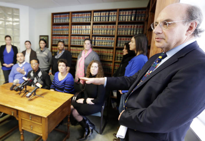 Attorney Alphonse Gerhardstein, right, answers questions Monday, Feb. 10, 2014, during a news conference in Cincinnati. Four legally married gay couples filed a federal civil rights lawsuit Monday seeking a court order to force Ohio to recognize same-sex marriages on birth certificates despite a statewide ban. (AP Photo/Al Behrman)