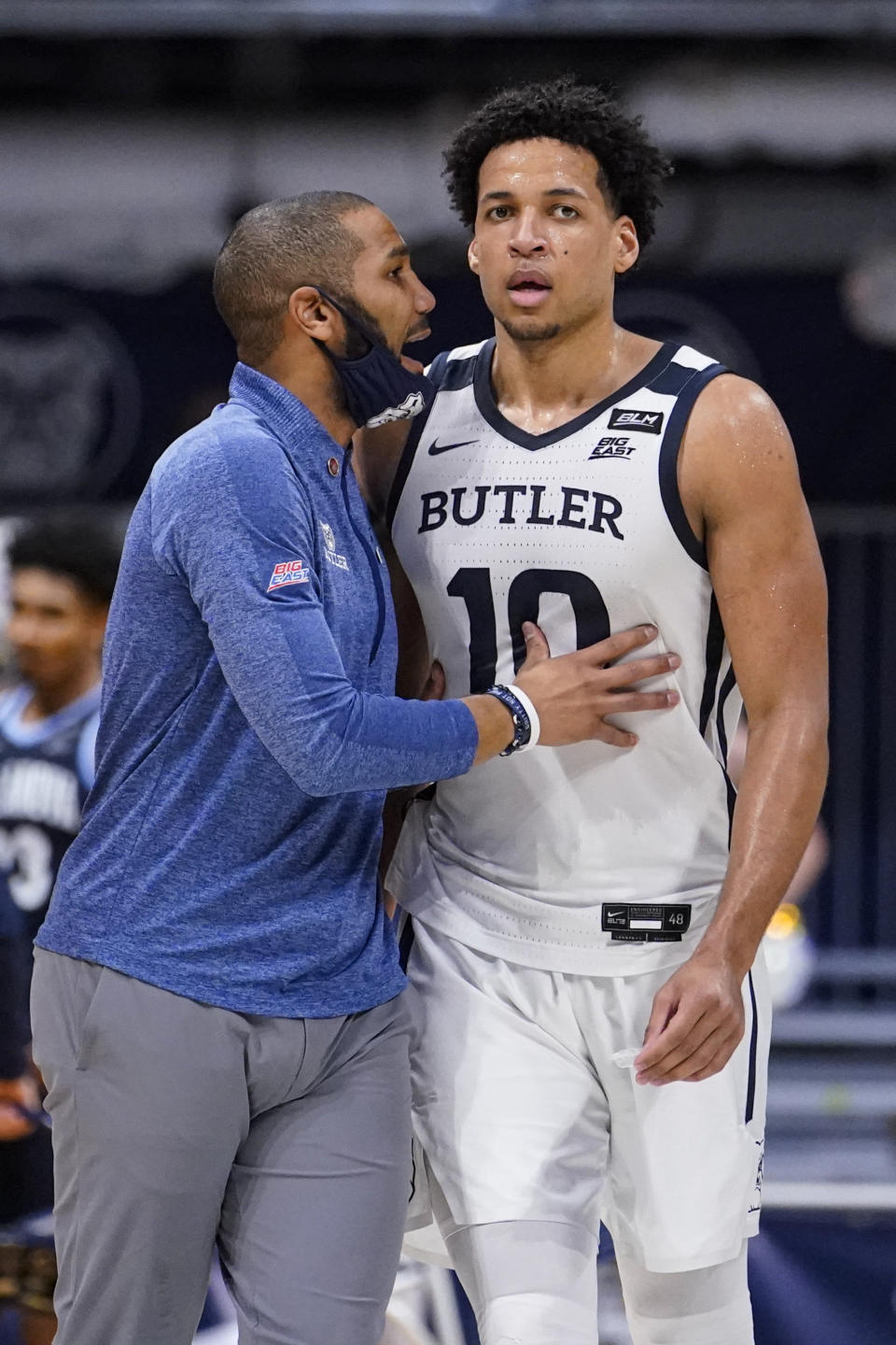 Butler head coach LaVall Jordan talks with forward Bryce Nze (10) in the first half of an NCAA college basketball game against Villanova in Indianapolis, Sunday, Feb. 28, 2021. (AP Photo/Michael Conroy)