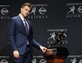 NCAA college football player, LSU quarterback Joe Burrow poses for a photo after winning the Heisman Trophy, Saturday, Dec. 14, 2019, in New York. (AP Photo/Jason Szenes)