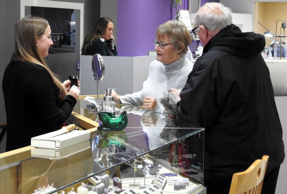 Carol and Bill Owens look at jewelry with sales associate Jessica Luce at Dean's Jewelry. The family owned business since 1965 offers a variety of men's and women's jewelry, including a custom line.