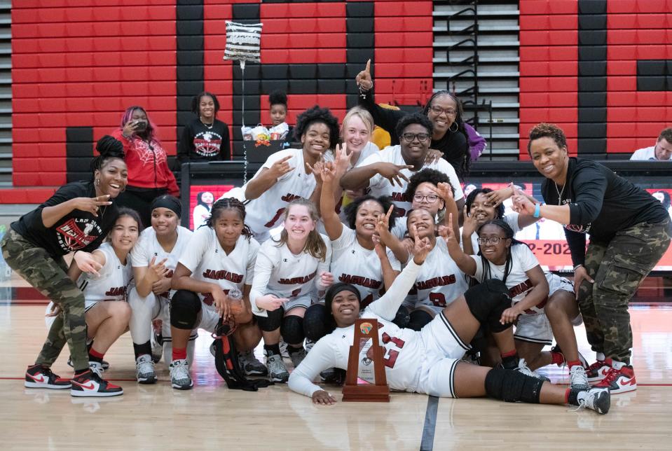 The Jaguars pose with the trophy after their victory in the South Walton vs West Florida 4A District 1 Girls Basketball Championship game at West Florida High School in Pensacola on Friday, Feb. 3, 2023.