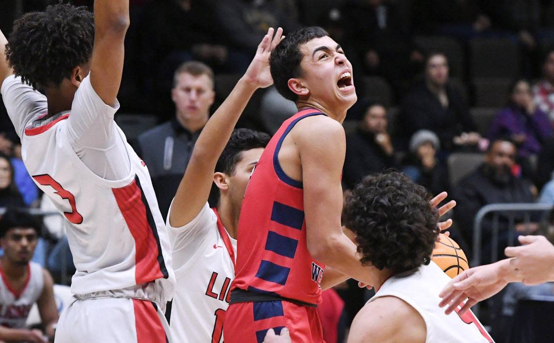 Tulare Western’s Malachi Ficher, center, struggles to control the ball against Kerma at the CIF Central Section Division IV basketball championship Friday, Feb. 24, 2023 in Fresno.