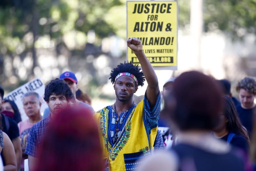 Colton Jones protests outside LAPD headquarters in response to the police shooting deaths of Alton Sterling and Philando Castille.