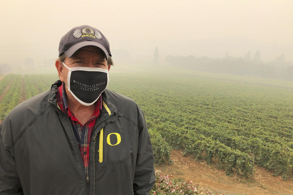 Jim Bernau, founder and winegrower of Willamette Valley Vineyards, speaks at his winery blanketed in smoke from wildfires on Thursday, Sept. 17, 2020, in Turner, Ore. Bernau said of the smoke: “I’ve been here growing wine grapes for over 38 years, and I have never experienced or seen anything like this as a wine grower.” (AP Photo/Andrew Selsky)