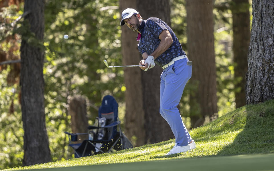 New York Jets quarterback Aaron Rodgers watches the ball after taking a swing in the first round of the American Century Championship celebrity golf tournament at Edgewood Tahoe Golf Course in Stateline, Nev., Friday, July 14, 2023. (Hector Amezcua/The Sacramento Bee via AP)