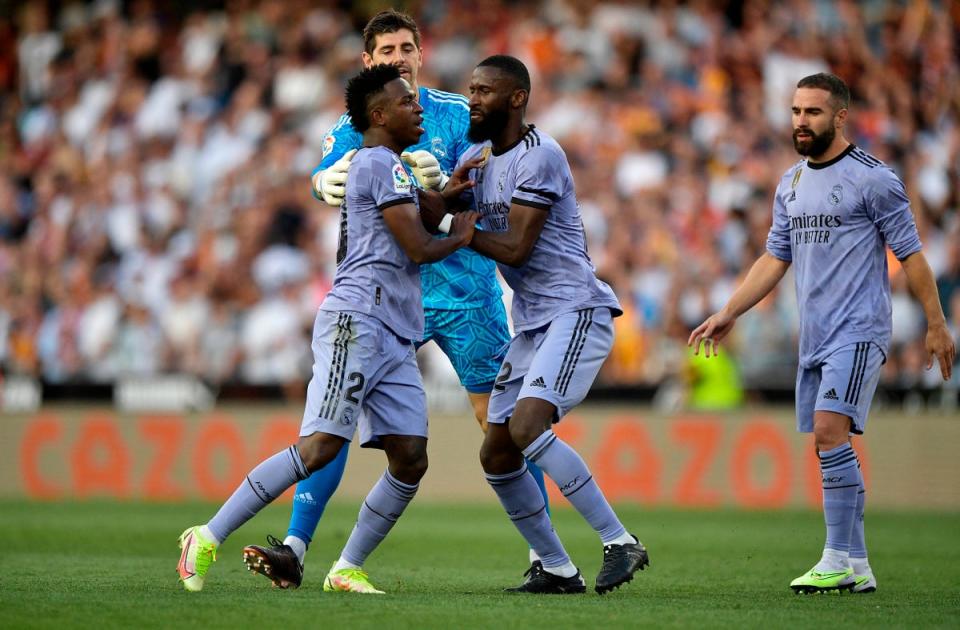 Real Madrid’s Vinicius Junior is restrained by Antonio Rudiger and Thibaut Courtois after being sent off (REUTERS)