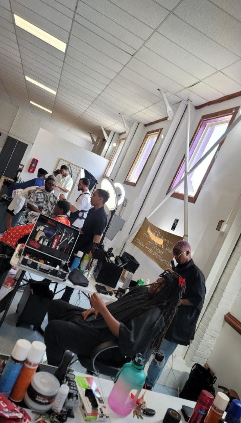 Students in the Barbering program at Craven Community College are pictured providing free haircuts to local residents.