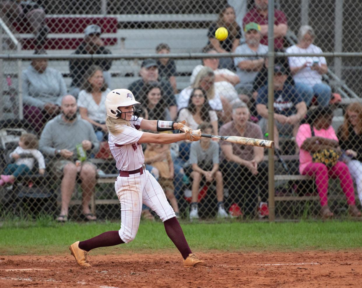 Jessica Farrer (8) puts the ball in play during the Gulf Breeze vs Navarre softball game at Navarre High School on Tuesday, April 26, 2022.