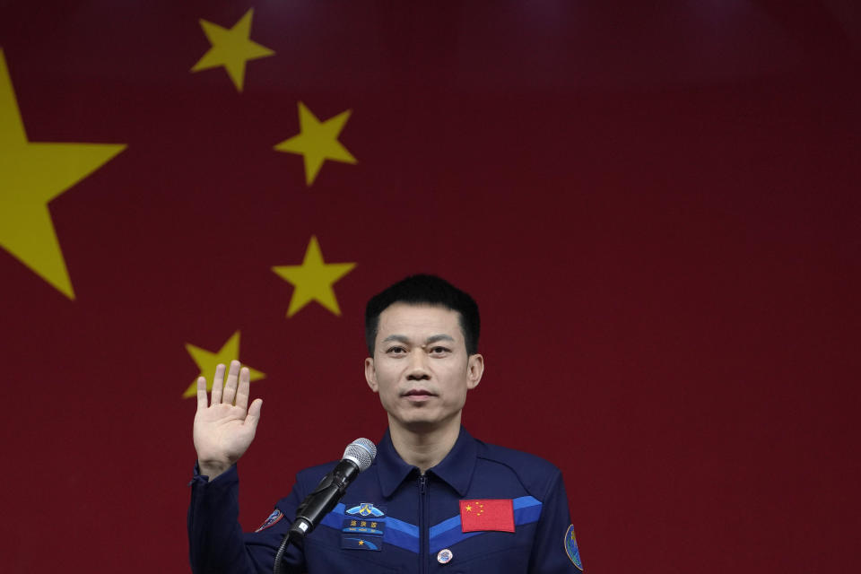 Tang Hongbo, a Chinese astronaut and commander for the upcoming Shenzhou-17 mission waves during a meeting with the press at the Jiuquan Satellite Launch Center in northwest China, Wednesday, Oct. 25, 2023. (AP Photo/Andy Wong)