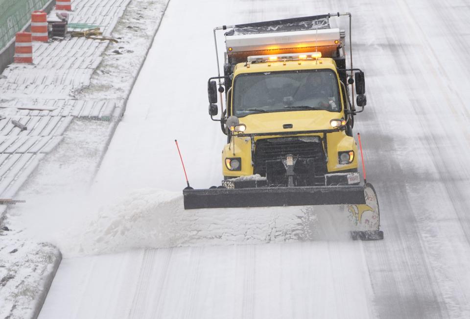 As sleet coats the roads in a layer of ice, a snow plow clears Olentangy River Road near Riverside Methodist Hospital in Columbus on Thursday, Feb. 3, 2022. Winter weather and poor road conditions closed many schools and businesses on Thursday. 