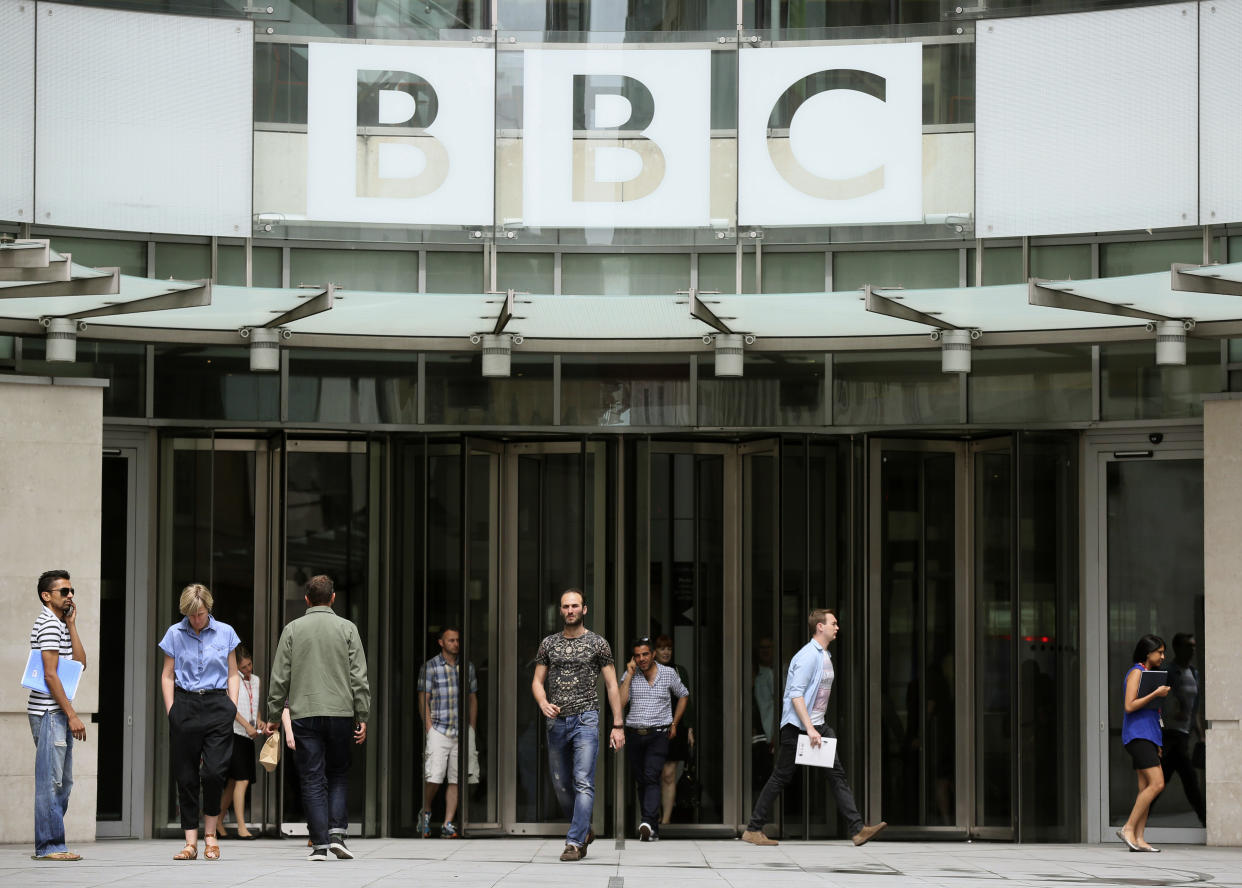 People arrive and depart from Broadcasting House, the headquarters of the BBC, in London Britain July 2, 2015. The BBC said it will cut more than 1,000 jobs because it expects to receive 150 million pounds ($234 million) less than forecast from the licence fee next financial year as viewers turn off televisions and watch programmes on the Internet.  REUTERS/Paul Hackett 