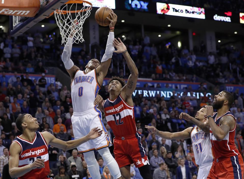 Russell Westbrook skies over the Wizards for one of his 14 rebounds. (AP)