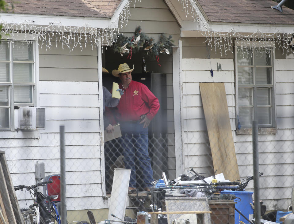 San Jacinto County Sheriff Greg Capers talks to investigators at the scene where five people were shot and killed the night before, Saturday, April 29, 2023, in unincorporated San Jacinto County, Texas. The suspect, Francisco Oropeza, who lives next door, is still at large. (Yi-Chin Lee/Houston Chronicle via AP)