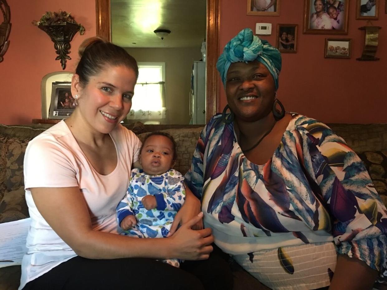 Jackie Martinez (left) holding the baby of Nikki Miltons, who she helped at Healthier Moms and Babies in Fort Wayne, Indiana.