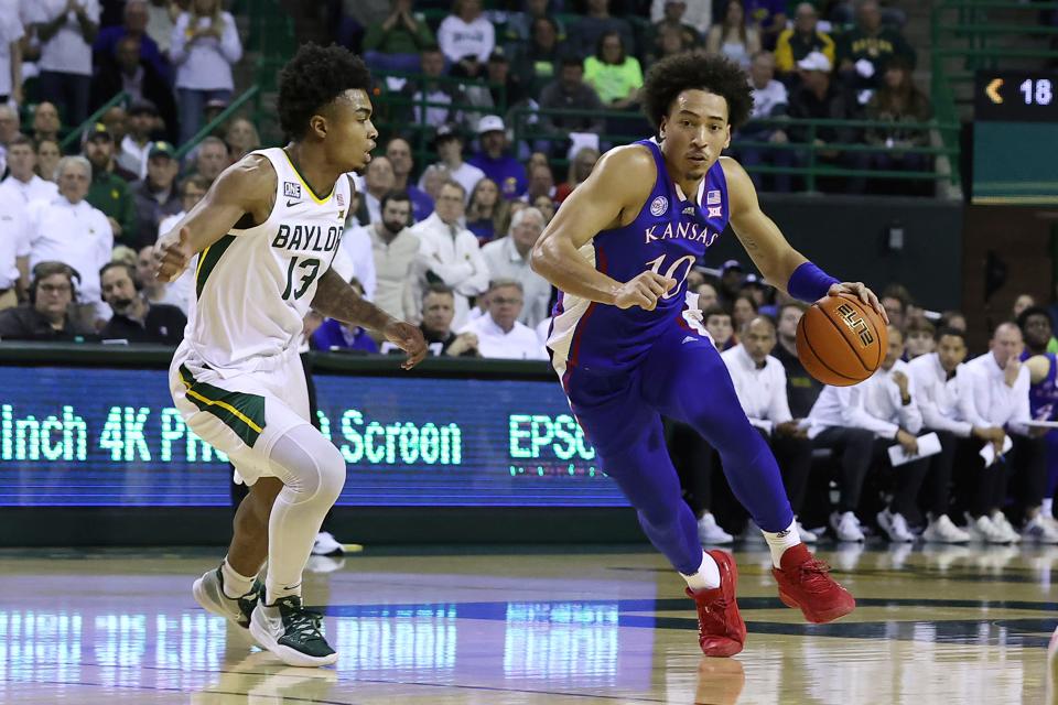Kansas forward Jalen Wilson (10) drives the ball up the court against Baylor guard Langston Love (13) during the first half of a game Monday in Waco, Texas.