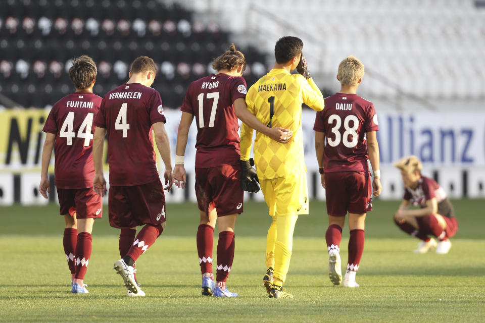 Vissel Kobe walk off the field in dejection end the Champions League semifinal soccer match between Vissel Kobe and Ulsan Hyundai FC at Jassim Bin Hamad Stadium in Doha, Qatar, Sunday, Dec. 13, 2020. (AP Photo/Hussein Sayed)