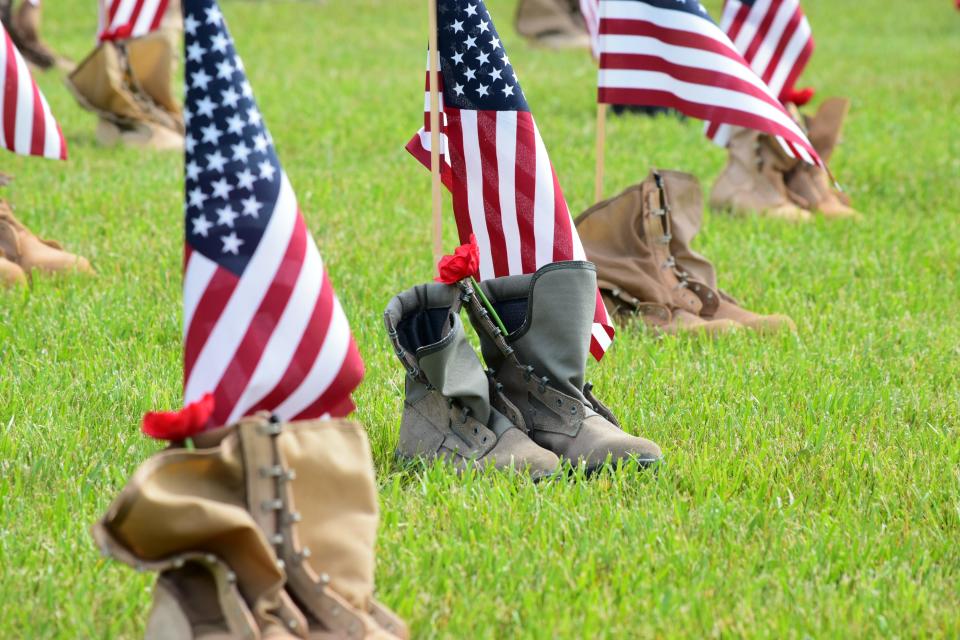 A total of 154 boots representing one week of veteran casualties due to suicide lined a field at the ceremony.