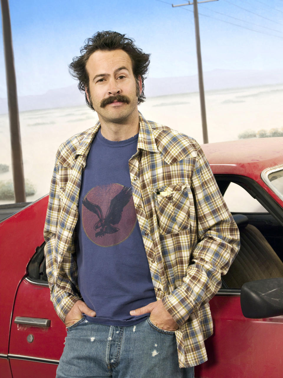 Jason Lee standing by a car