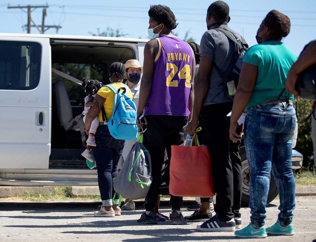 Haitian migrants who are seeking asylum wait to get into a van to be transported from Del Rio, Texas, the United States, Sept. 24, 2021. (Nick Wagner/Xinhua via Getty Images)
