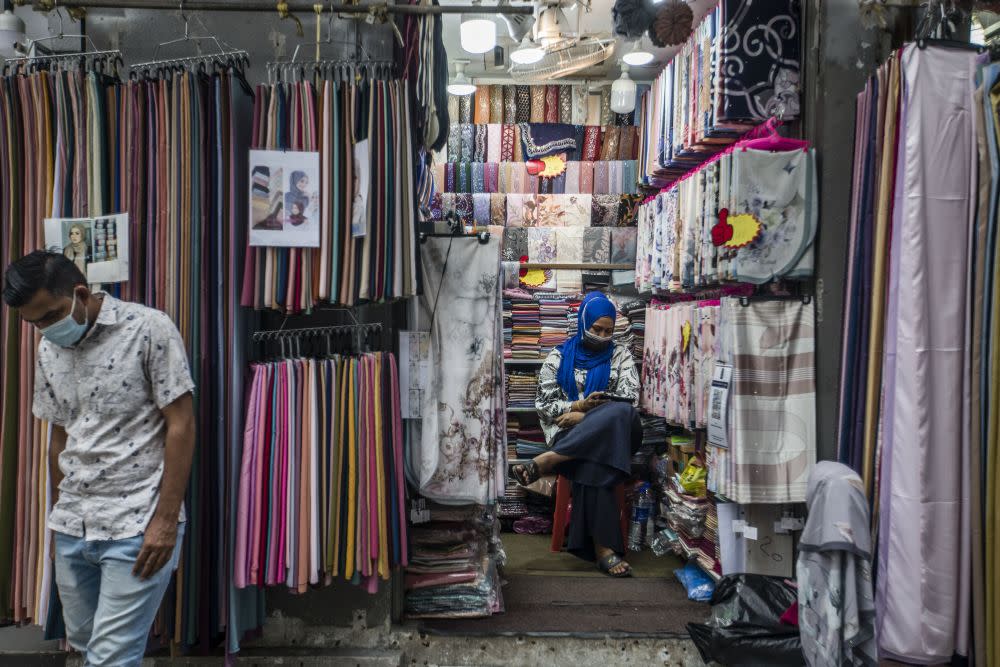 Street vendors are seen waiting for customers on Jalan Tuanku Abdul Rahman amid the conditional movement control order in Kuala Lumpur October 23, 2020. — Picture by Firdaus Latif