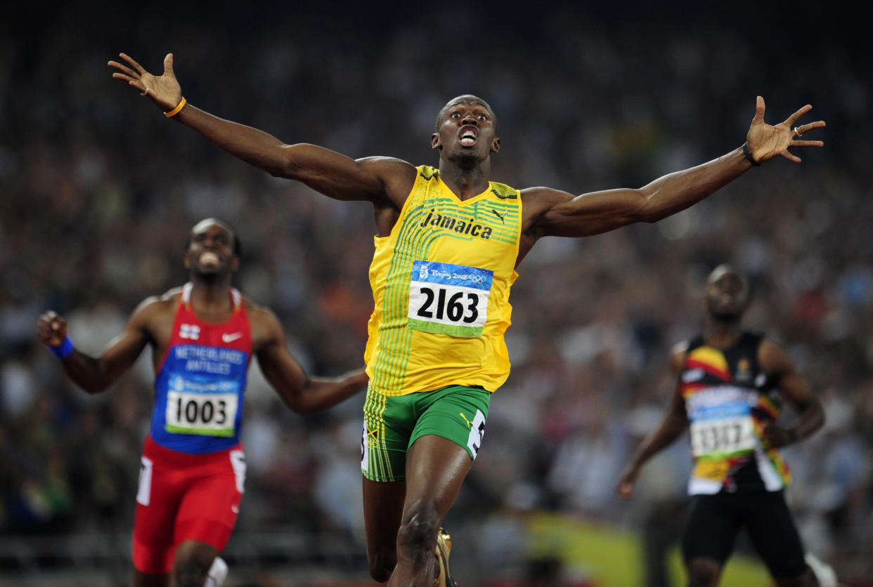 Usain Bolt, sporting Packers colors in 2008, wants Aaron Rodgers to stay in Green Bay. (Dylan Martinez / Reuters)